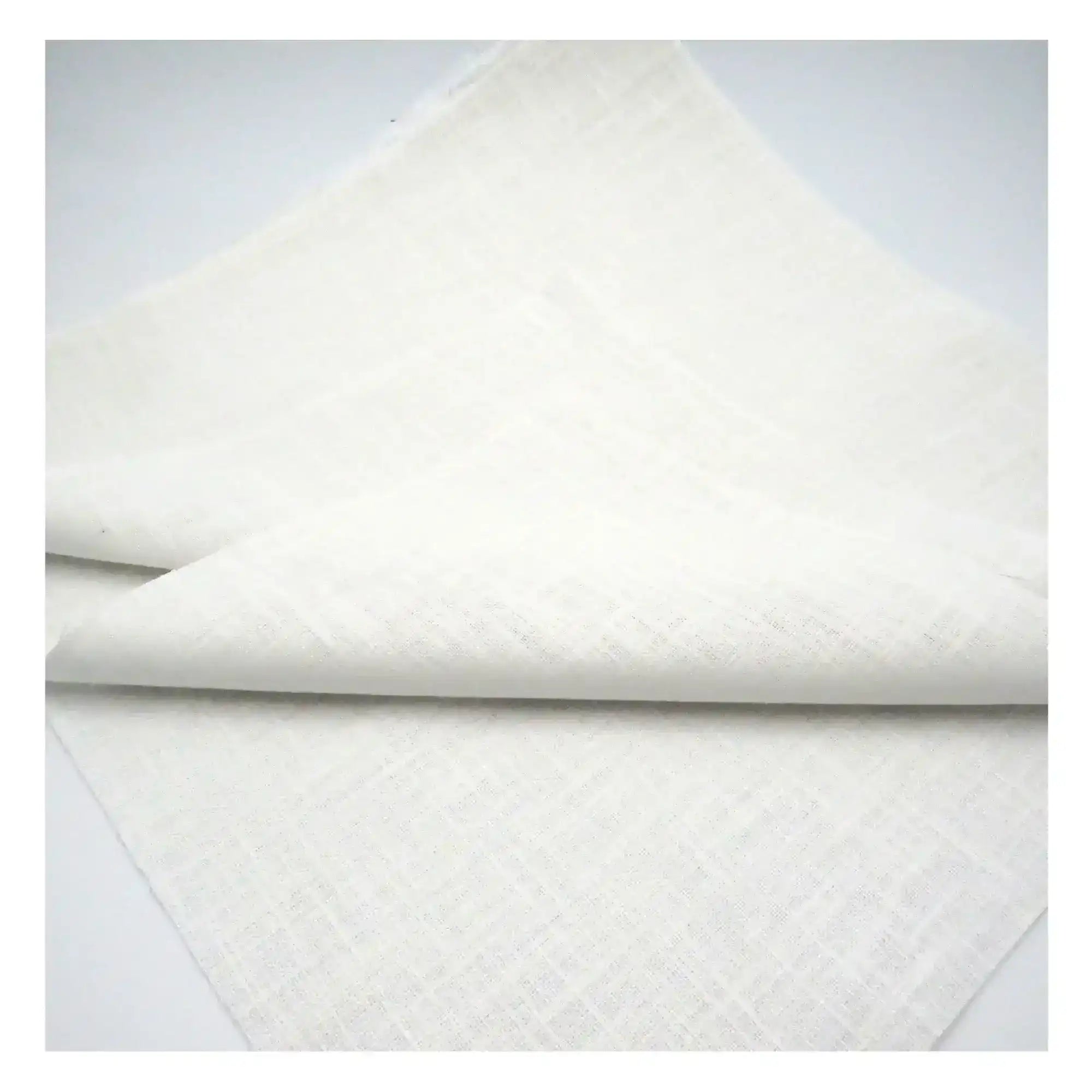 Quilted white fabric on a light gray background