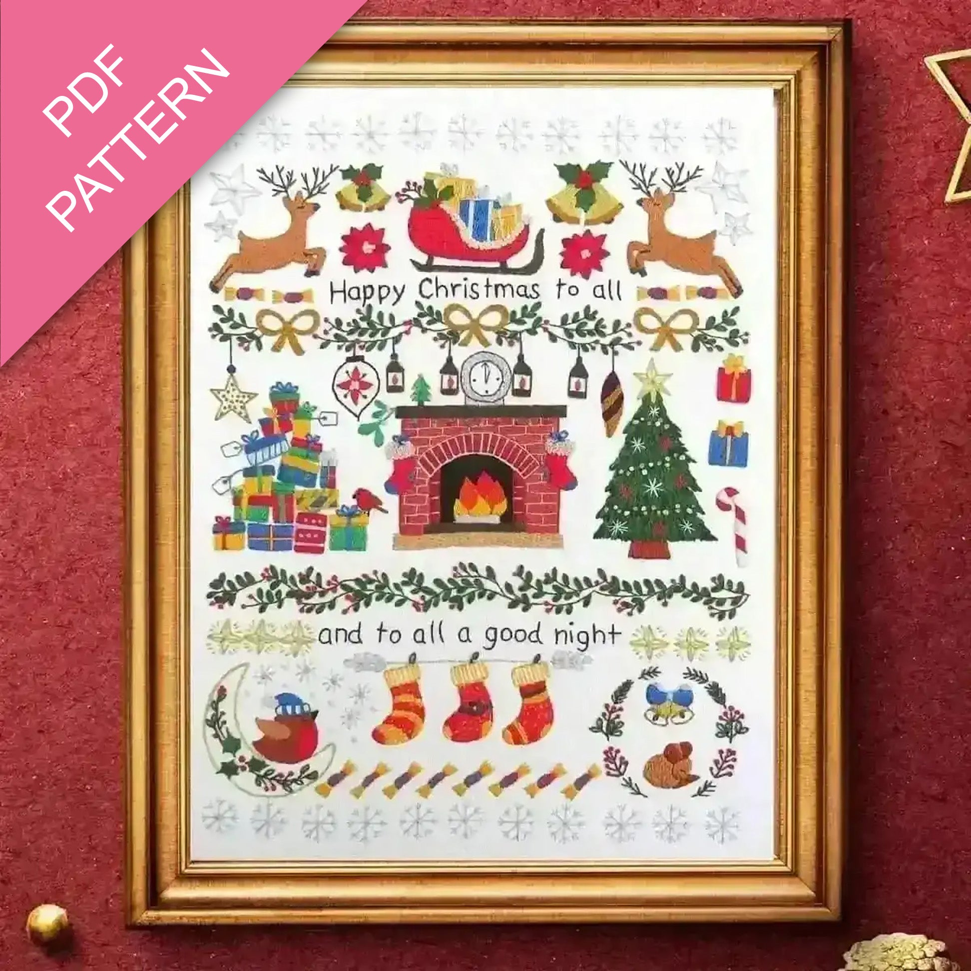 Framed Christmas-themed cross-stitch pattern with decorative elements on a red background.