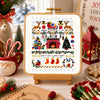 Christmas-themed cross-stitch design on a lightbox with festive decorations around.