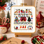 Christmas-themed cross-stitch design on a lightbox with festive decorations around.