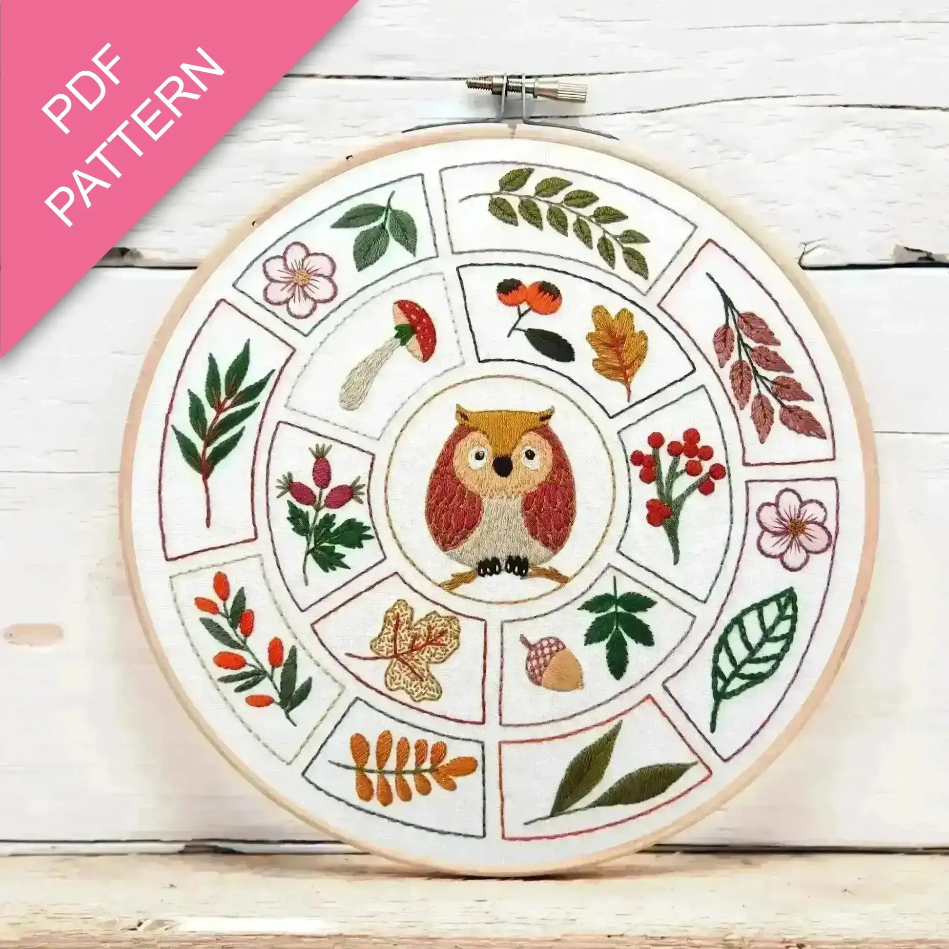 Embroidery hoop with owl design and floral patterns on a wooden surface, featuring 'PDF Pattern' text.