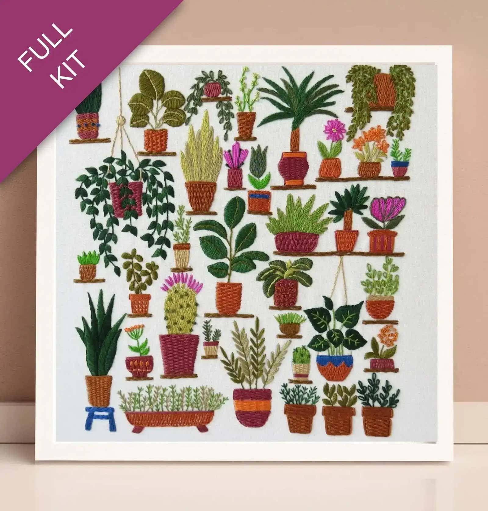 Embroidery kit with a design of various potted plants on a white background.