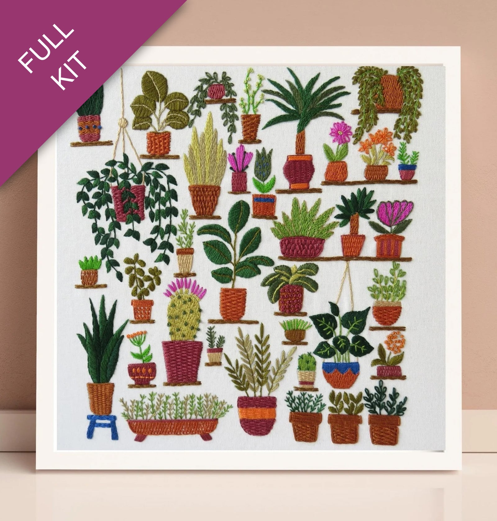 Embroidery kit with a design of various potted plants on a white background.