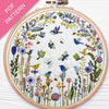 Embroidery hoop with floral and bird design on a white background
