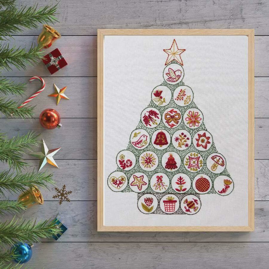 Four embroidered designs featuring flowers and a Christmas tree on a white background with green borders.
