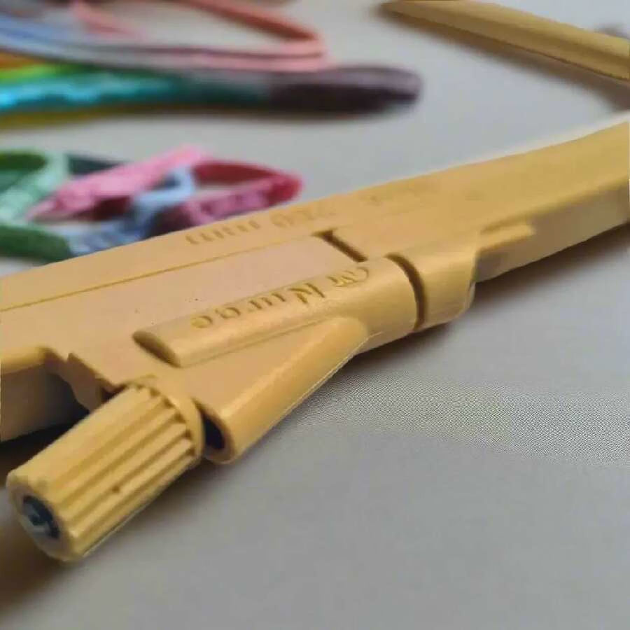 Yellow embroidery hoop on a wooden surface