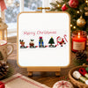 Christmas-themed cross-stitch design with festive decorations on a wooden table.