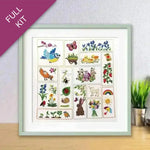 Framed poster with various illustrations of animals, plants, and nature on a wooden surface.