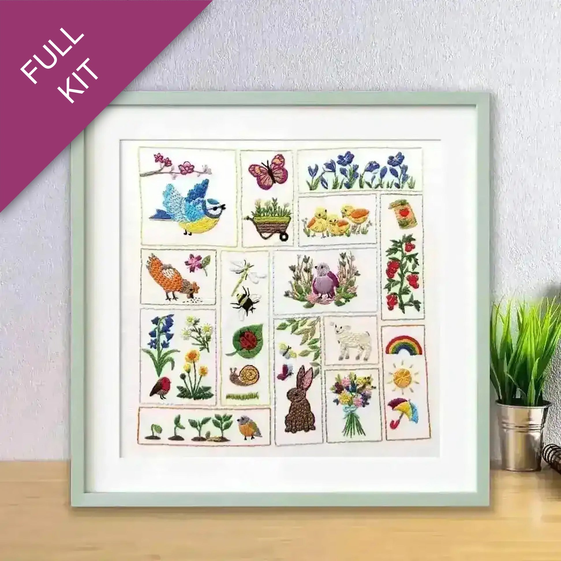 Framed poster with various illustrations of animals, plants, and nature on a wooden surface.