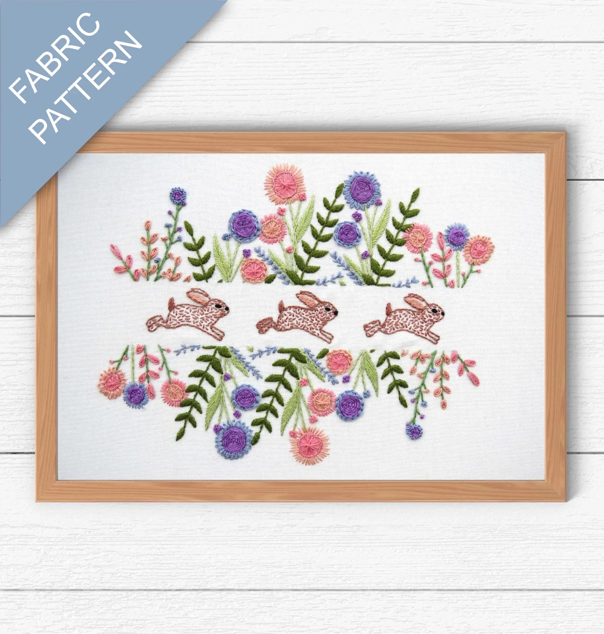 Embroidery pattern with rabbits and flowers on a white background