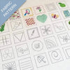 Collection of embroidered patterns on fabric with various designs including birds, flowers, and geometric shapes.