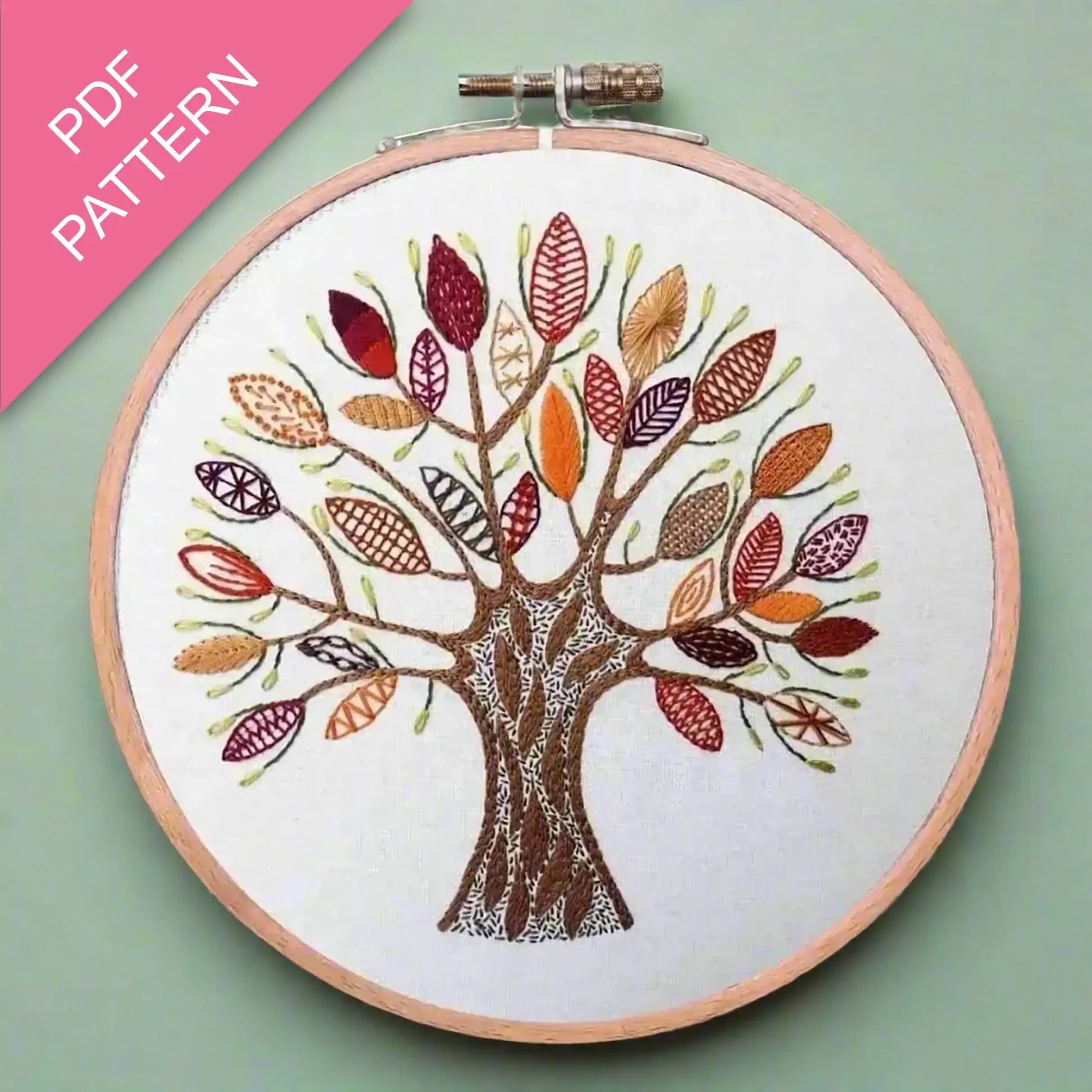 Embroidery hoop with a colorful tree design on a light green background, featuring 'PDF Pattern' text.