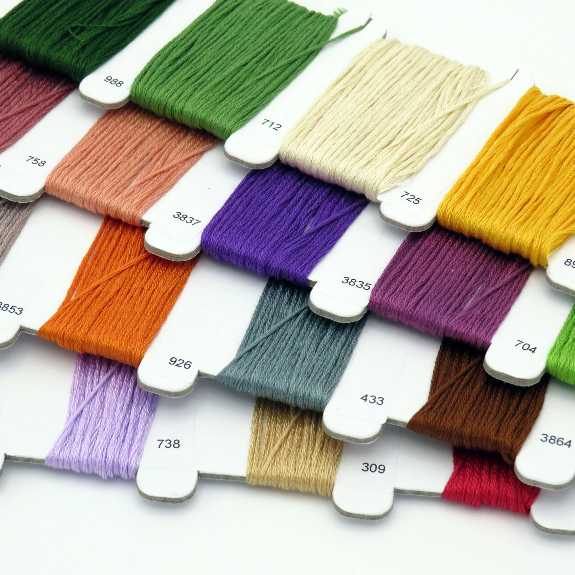 Assorted colorful embroidery threads on a white background