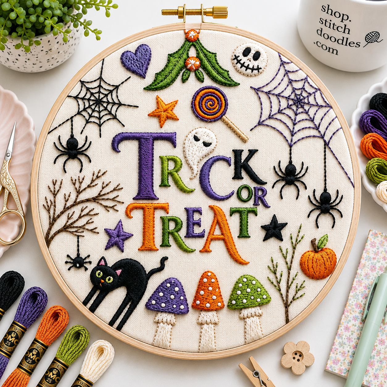 Embroidery hoop with Halloween-themed designs and 'Trick or Treat' text, surrounded by embroidery supplies.