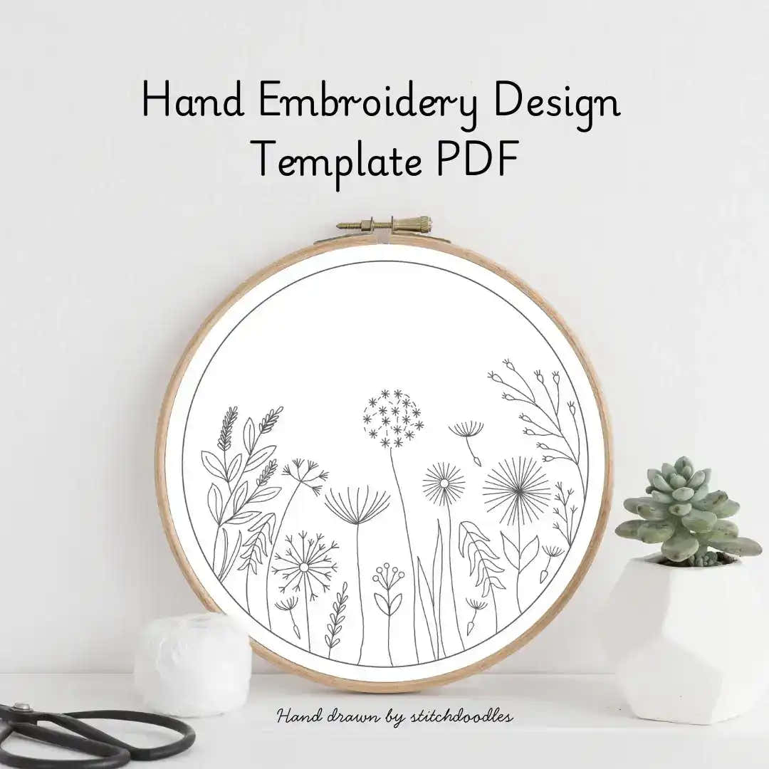 Hand embroidery design template with floral patterns in an embroidery hoop on a white background.