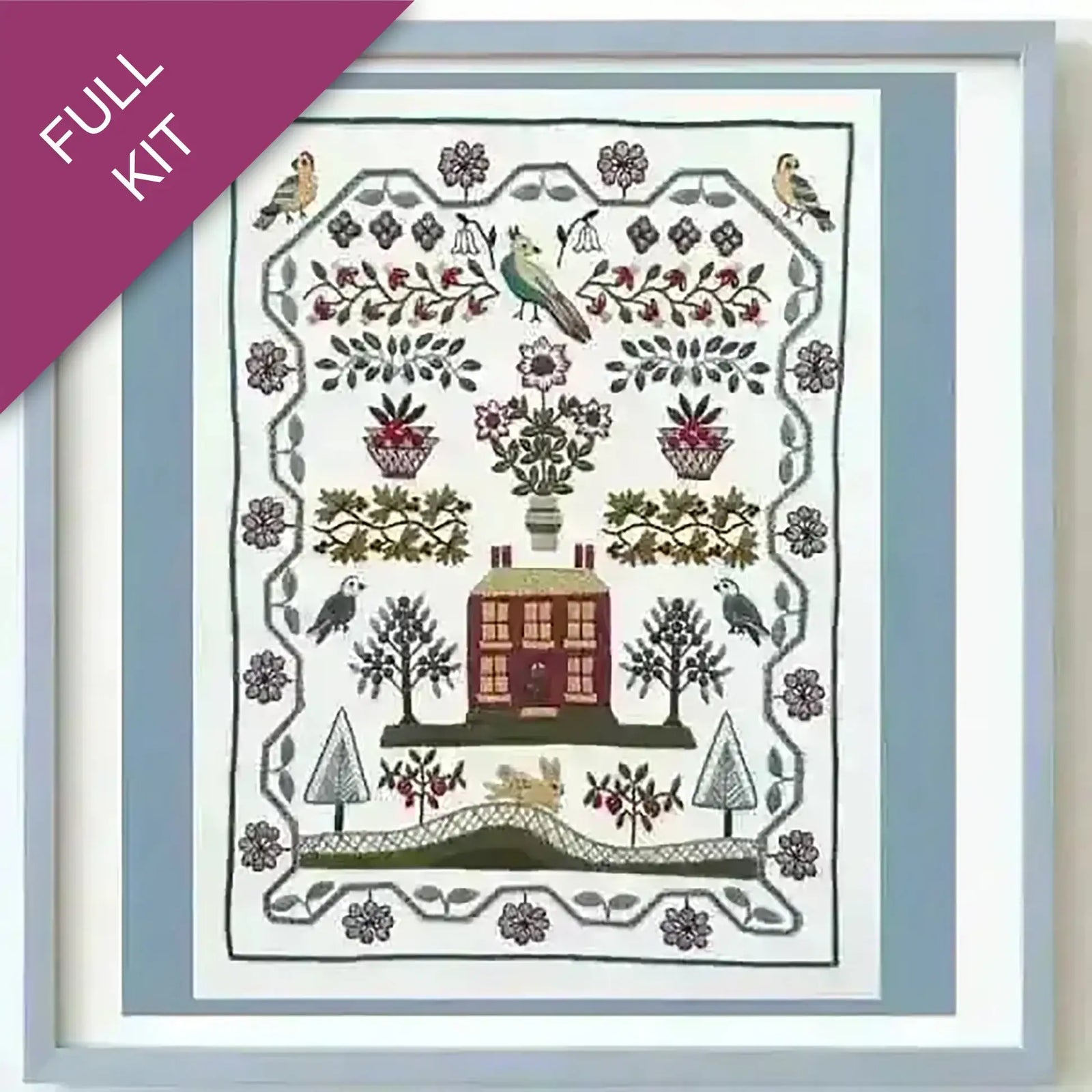 Embroidery kit with a pre-designed pattern featuring a house, trees, and birds.