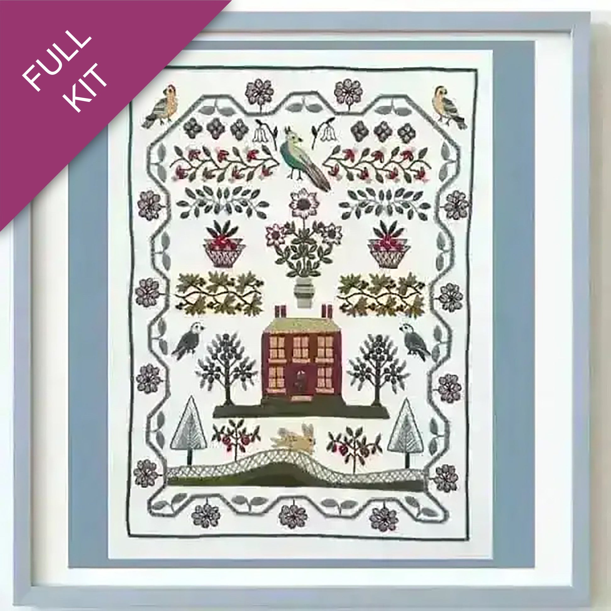 Embroidery kit with a pre-designed pattern featuring a house, trees, and birds.