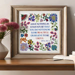 Framed floral print on a wooden table with decorative items