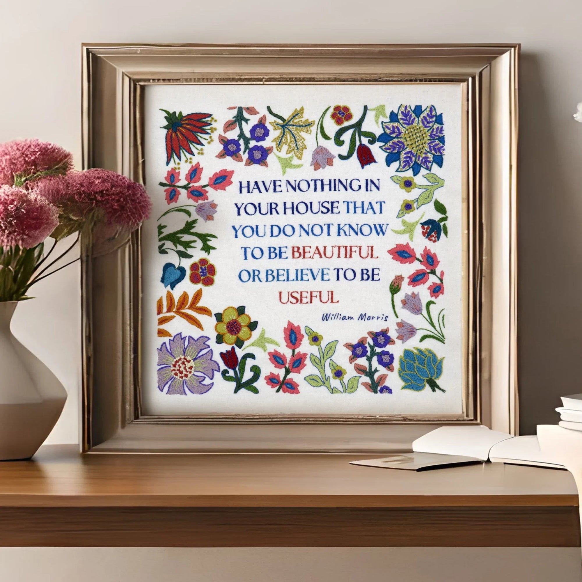 Framed floral print on a wooden table with decorative items